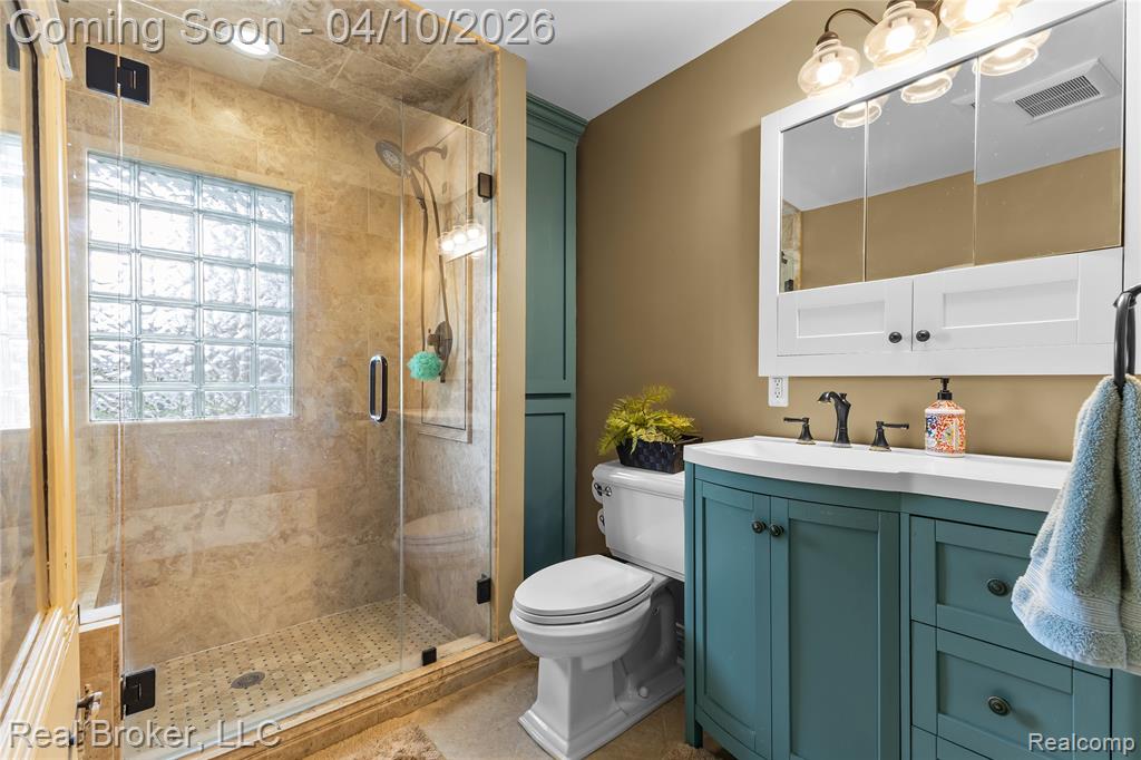 Full bathroom featuring vanity and a stall shower