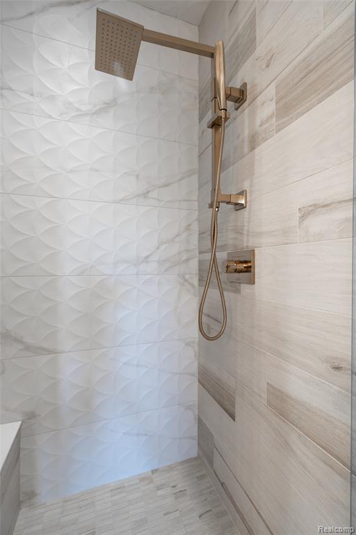 Bathroom featuring a tile shower