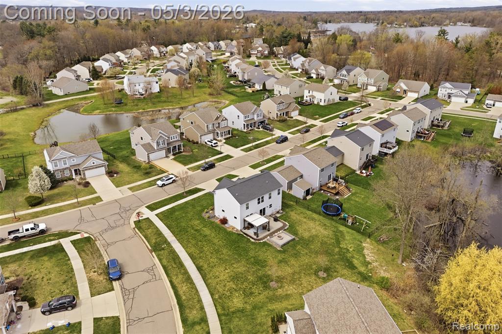 Aerial perspective of suburban area featuring a large body of water