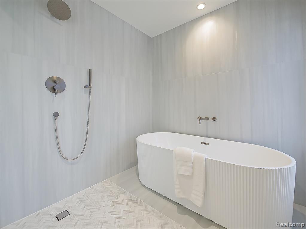 Bathroom with a freestanding bath and recessed lighting