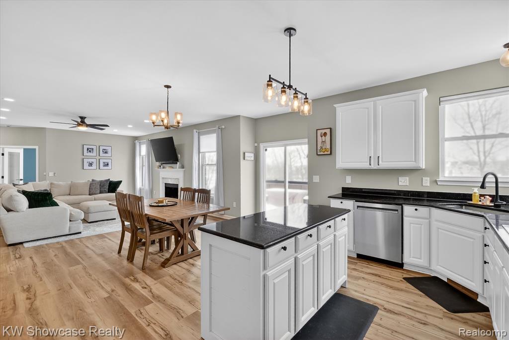 Kitchen with dark stone counters and white cabinets