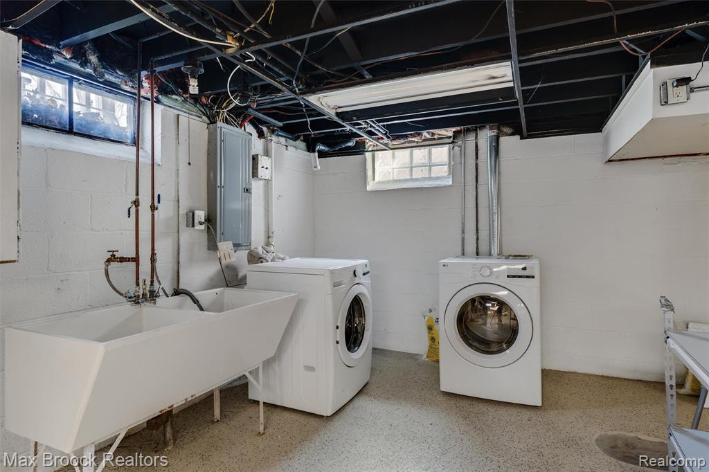 Laundry area with electric panel and washing machine and dryer
