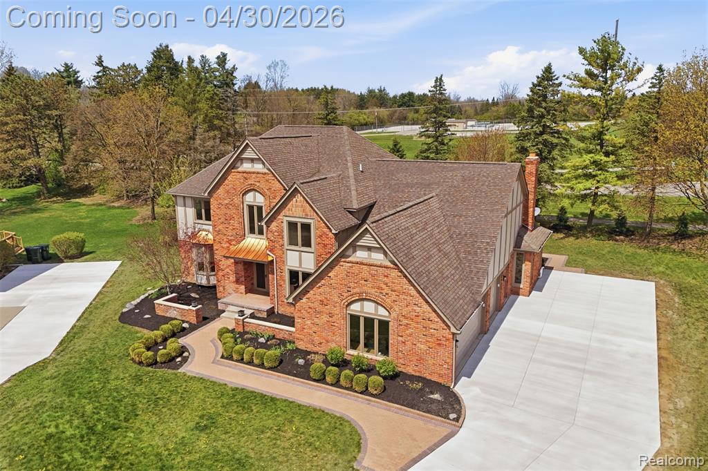 Aerial view of front of home featuring a front yard