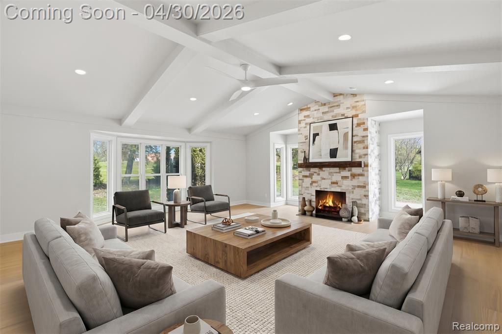Great Room area featuring light wood-style floors, ceiling fan, a fireplace, beam ceiling, and recessed lighting w/ wet bar
