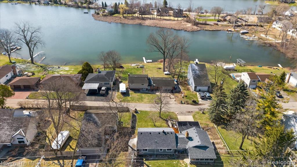 Aerial view of residential area featuring a nearby body of water