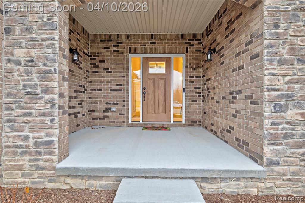 Entrance to property featuring brick siding