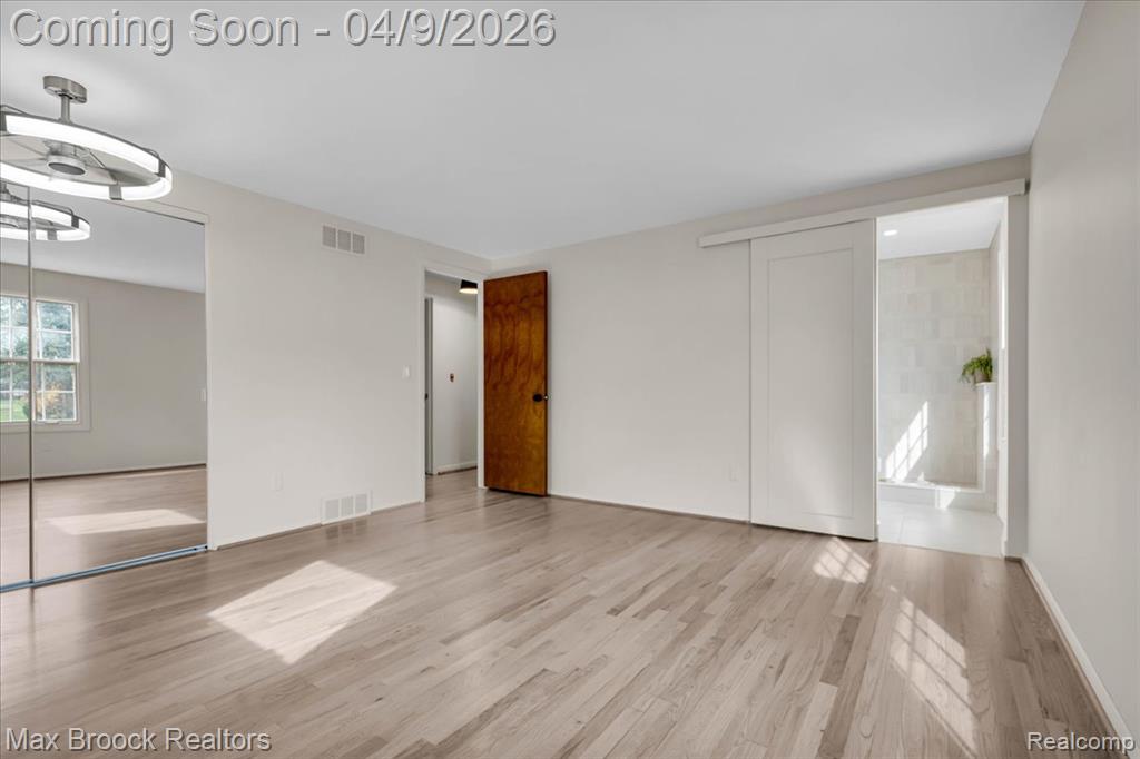 Unfurnished bedroom featuring light wood-style flooring