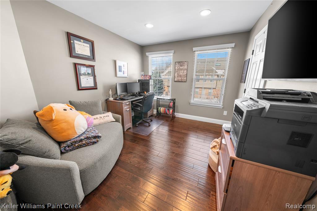 Office space with dark wood finished floors and recessed lighting