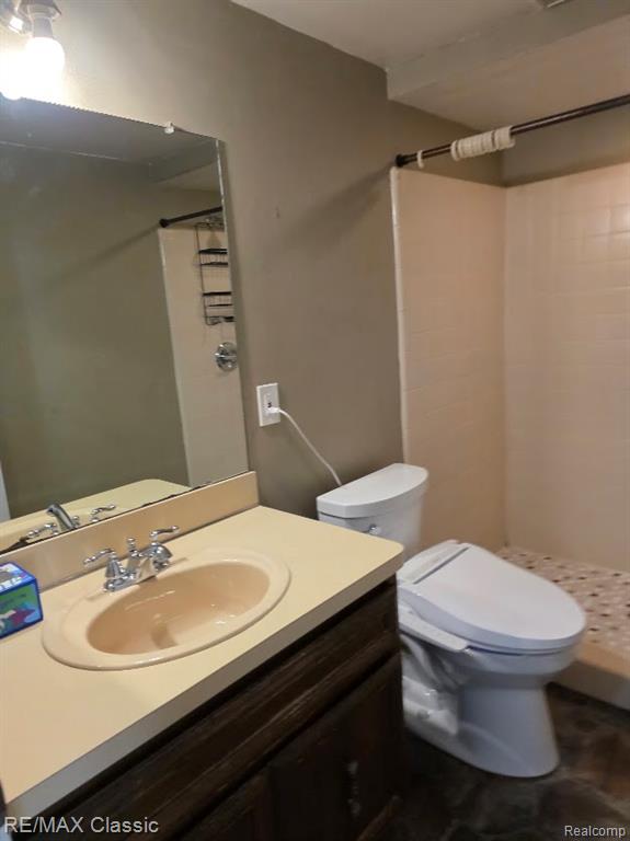 Full bathroom featuring vanity and a stall shower