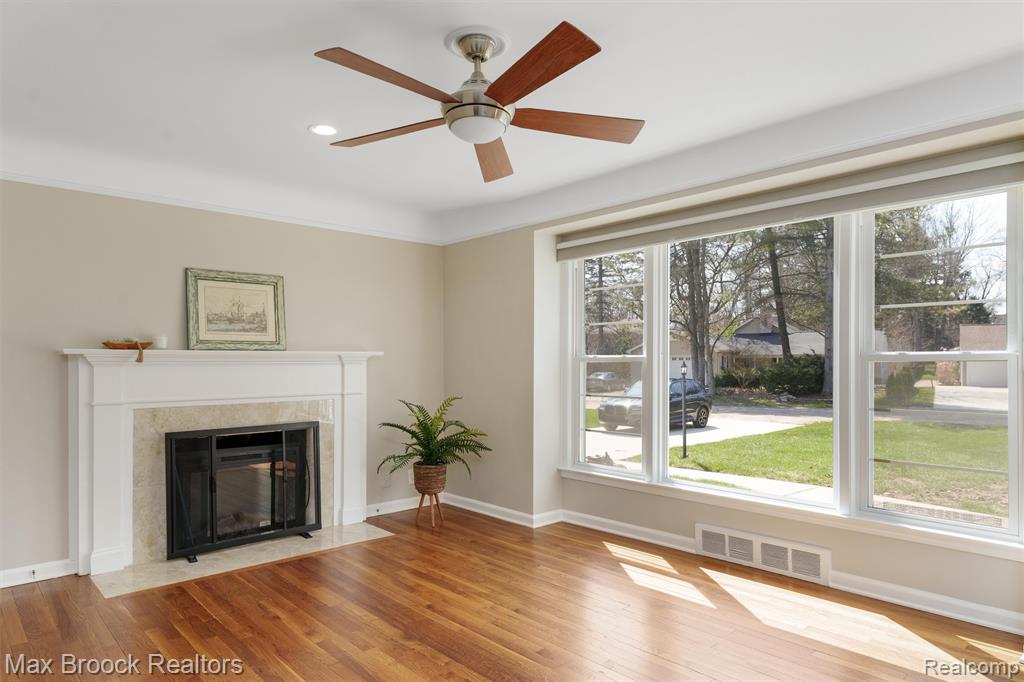 Unfurnished living room with light wood-style flooring, a ceiling fan, an electric fireplace, and recessed lighting