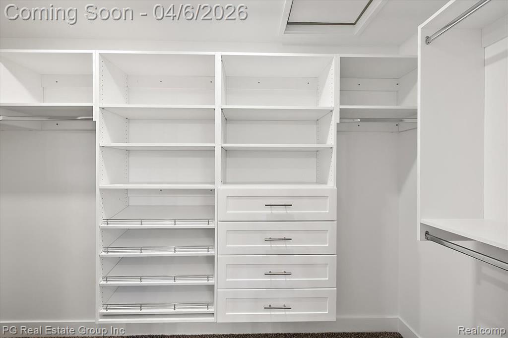 Walk in closet featuring attic access