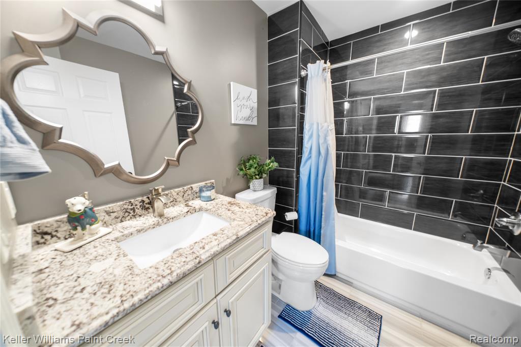 Full bathroom with vanity and shower / bath combination with curtain