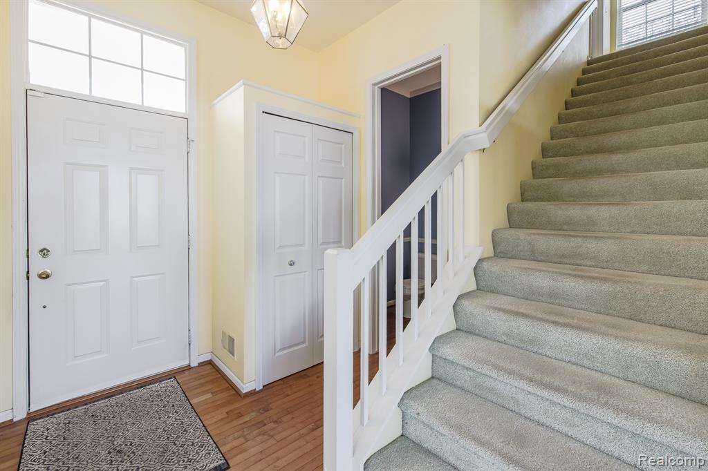 Entrance foyer featuring stairway and light wood finished floors