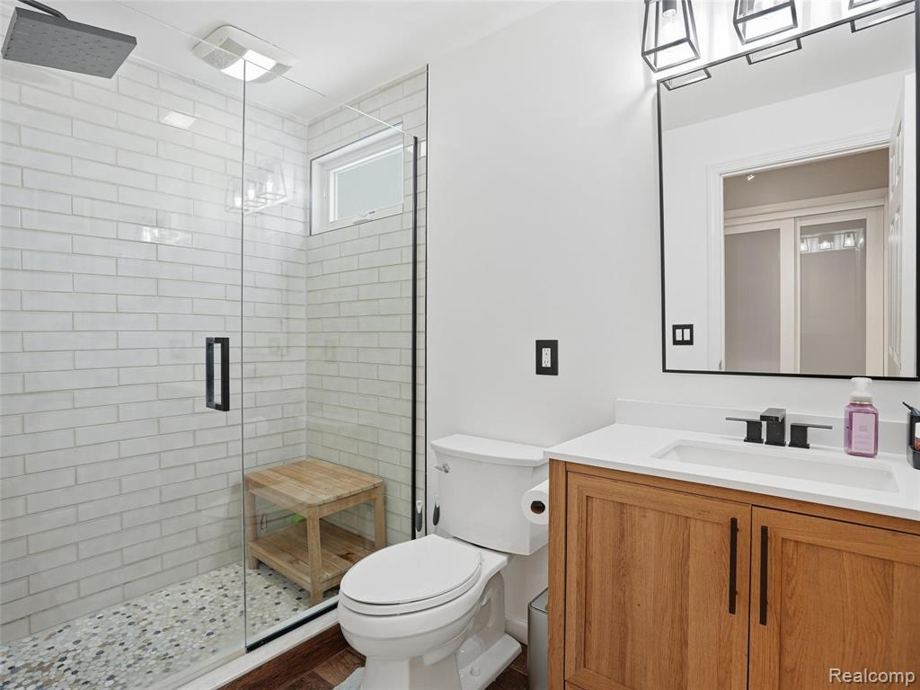 Full bathroom featuring a stall shower and vanity