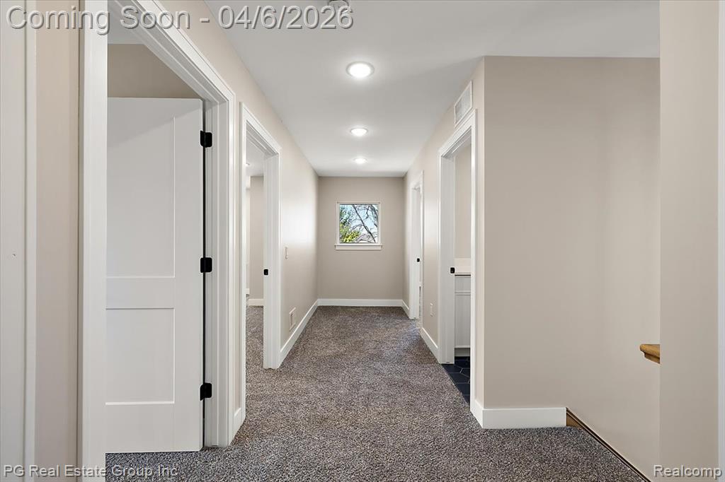 Hall featuring dark carpet and recessed lighting