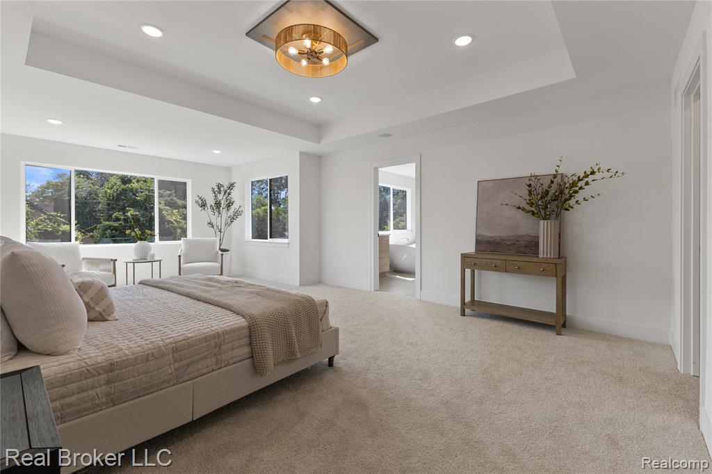 Living room with light wood-type flooring, a high ceiling, stairs, and recessed lighting