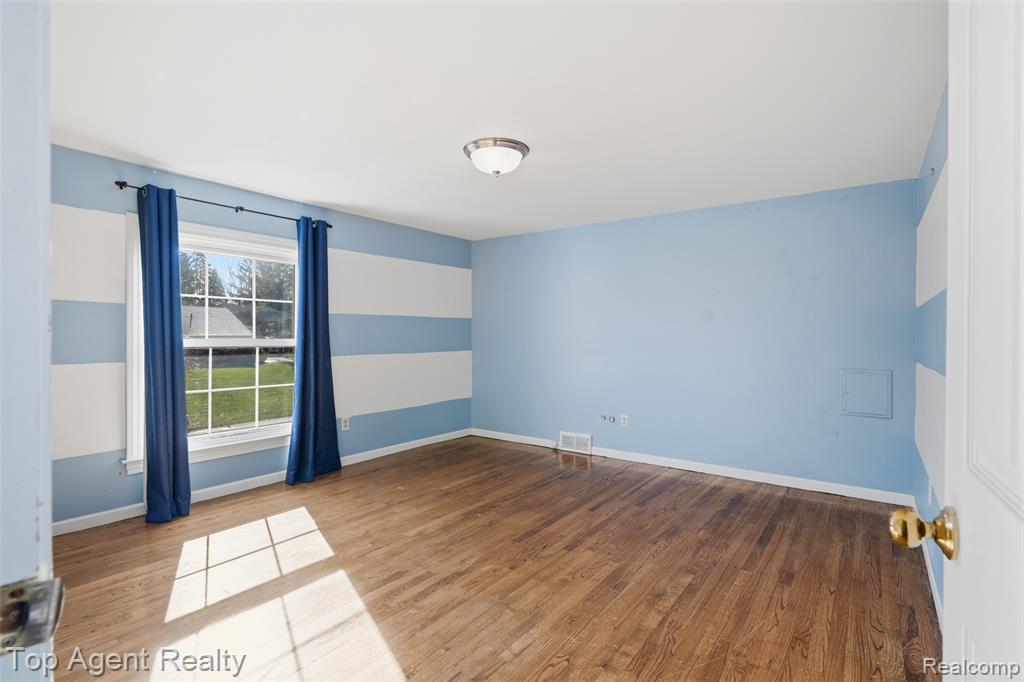 Unfurnished bedroom with two closets and light wood-type flooring