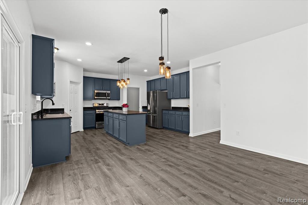 Empty room featuring dark carpet and stairs