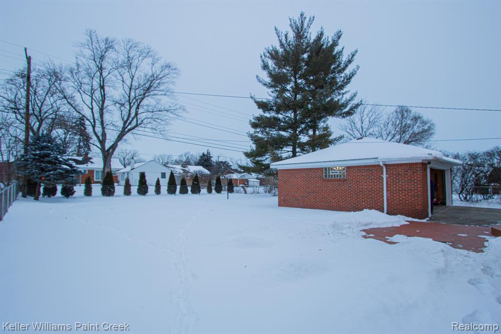Snowy yard with an outbuilding
