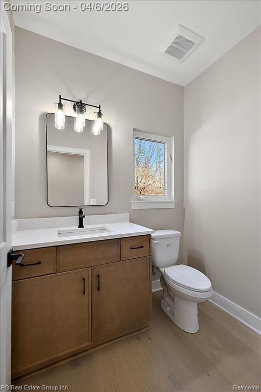 Bathroom featuring vanity and light wood finished floors