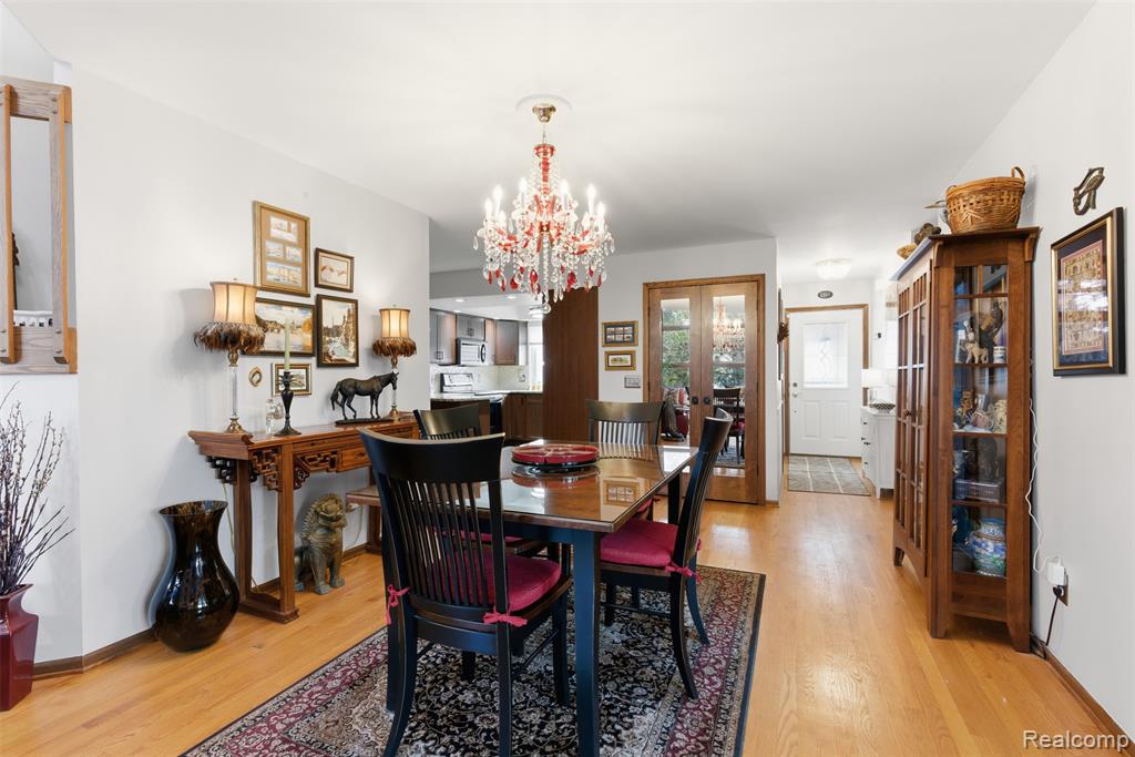 Dining space featuring hanging lights and light wood-type flooring