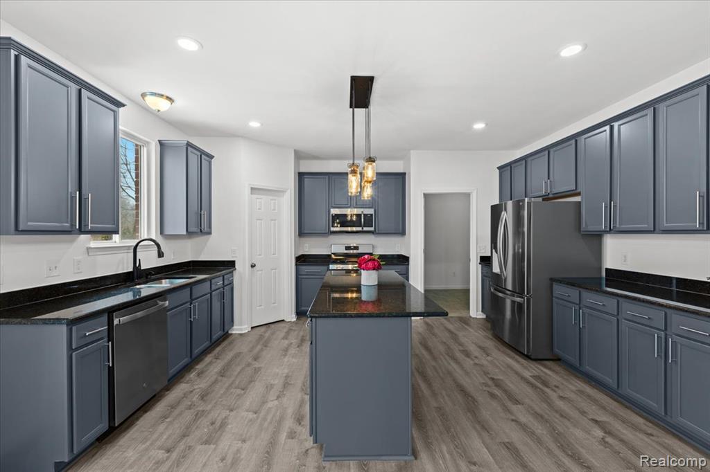 Bathroom featuring double vanity, a shower stall, a bathtub, and dark tile patterned flooring