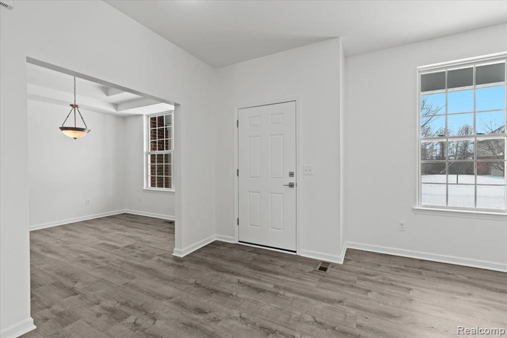 Half bathroom with toilet and baseboards