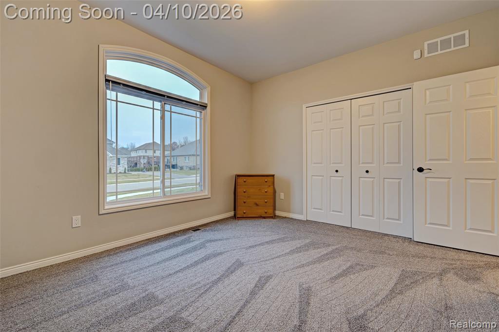 Unfurnished bedroom featuring carpet flooring and a closet