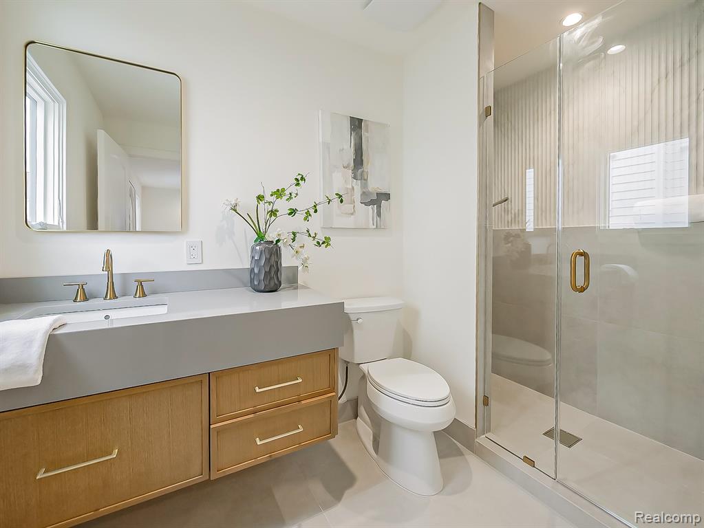 Full bath featuring a stall shower, vanity, and recessed lighting