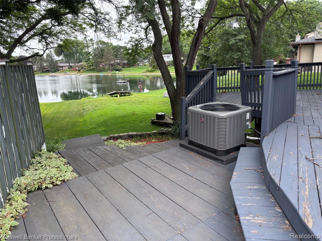 Wooden deck featuring a yard and a water view
