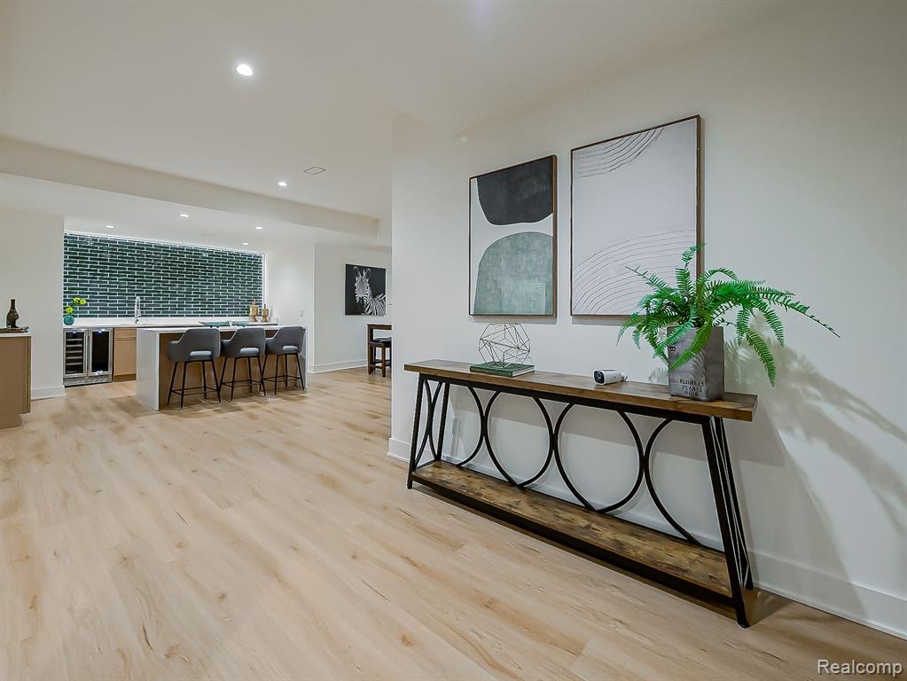 Hall with recessed lighting, light wood-style floors, and wine cooler