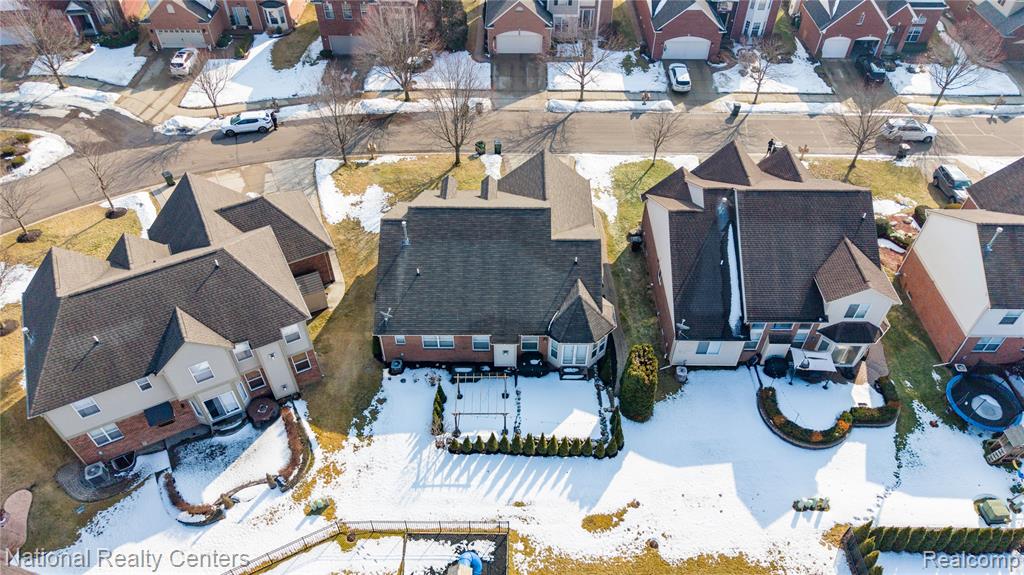 Snowy aerial view with a residential view