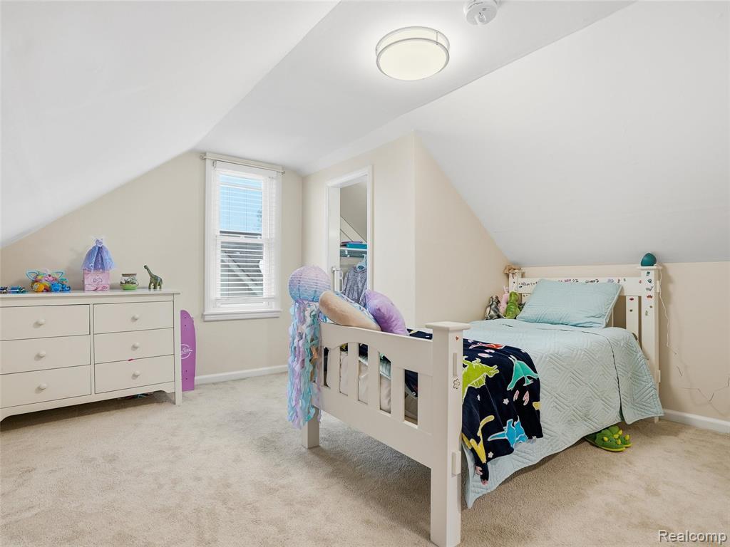 Bedroom featuring light carpet