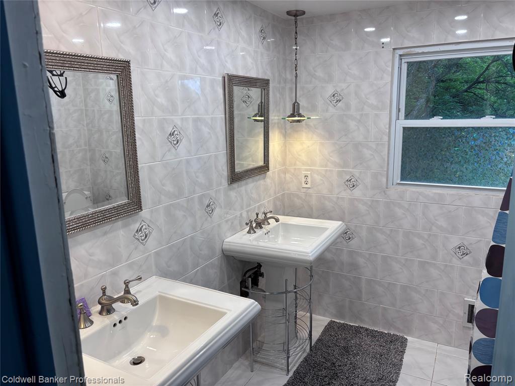 Bathroom featuring tile walls and tile patterned floors