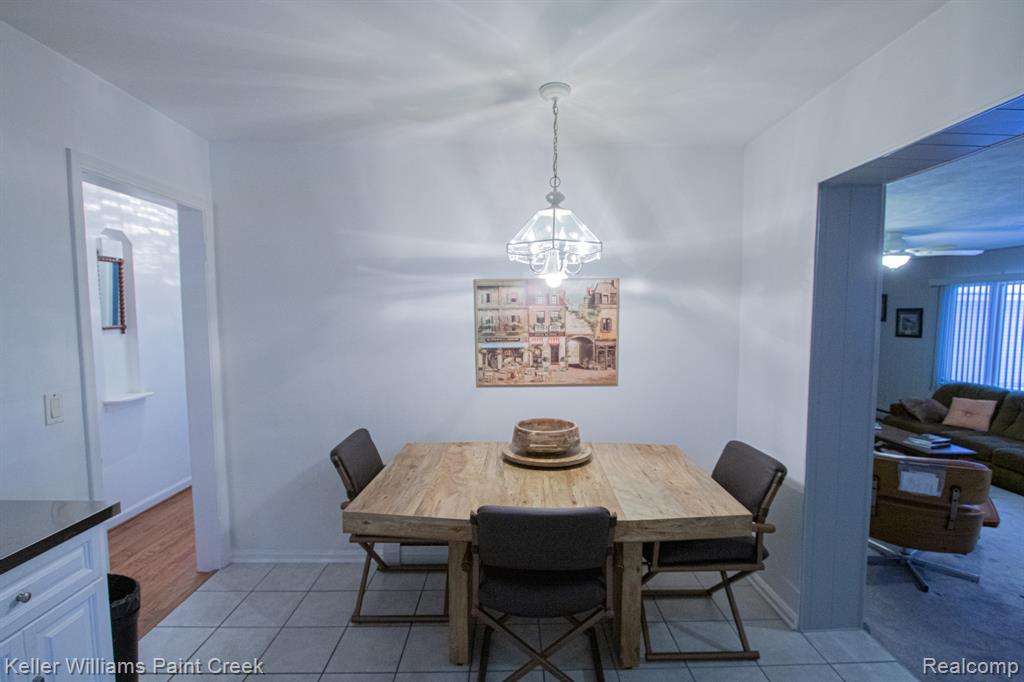 Dining area featuring light tile patterned floors and ceiling fan