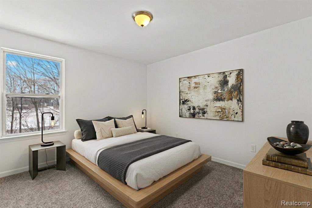 Unfurnished living room with a glass covered fireplace and wood finished floors