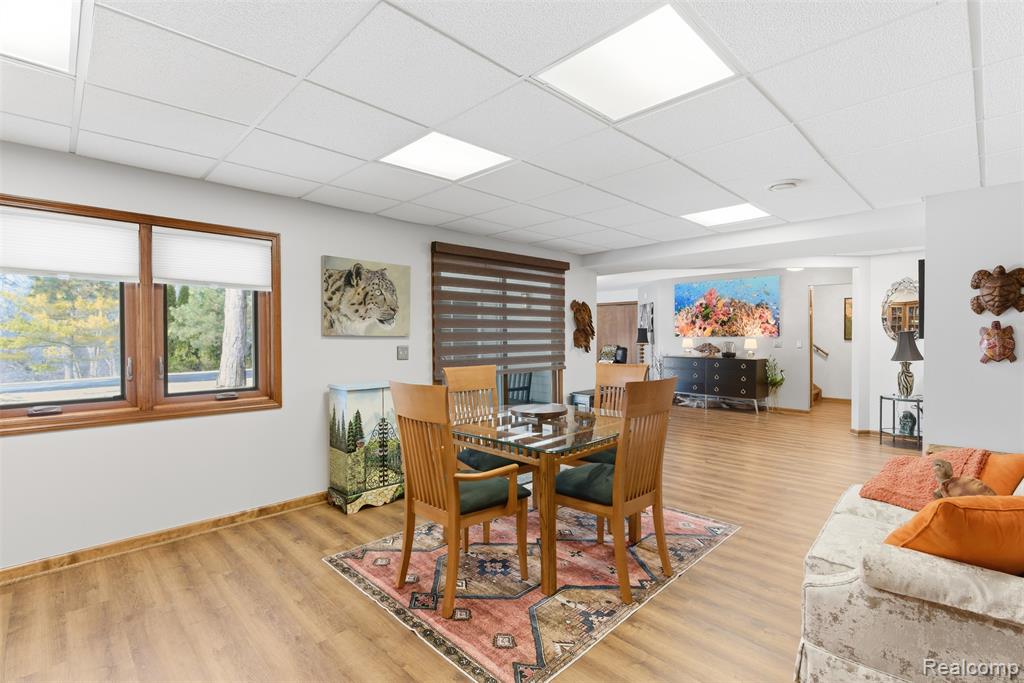 Dining space with light wood-style floors and a drop ceiling