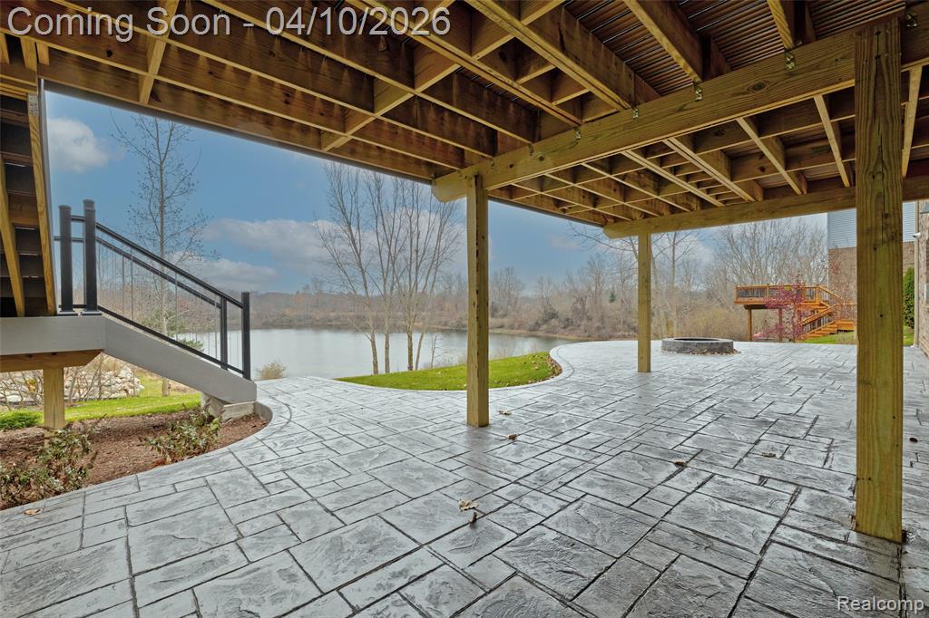 View of patio / terrace with a water view and an outdoor fire pit