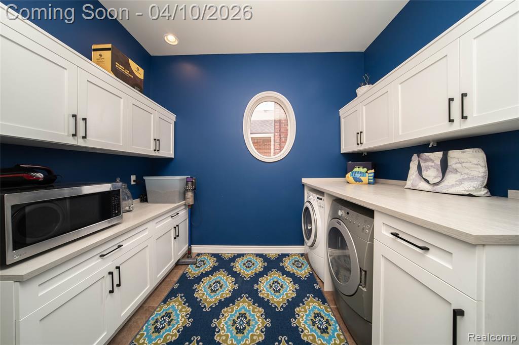 Laundry room with independent washer and dryer and cabinet space