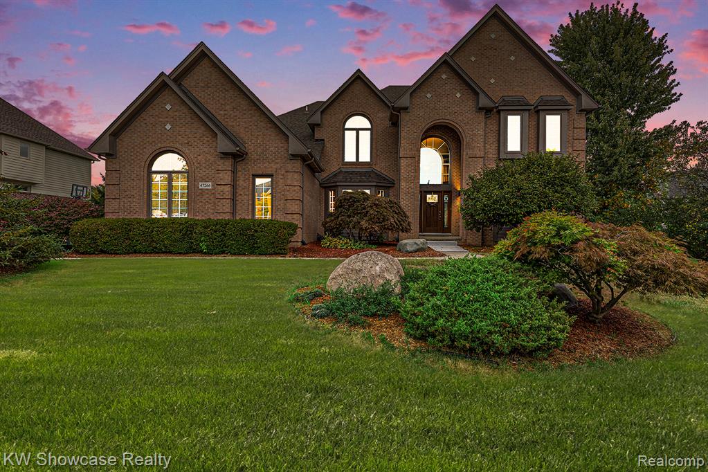 Photo for 47266 White Pines Drive, Novi, MI - listing #20251054091 View of front facade with brick siding and a front lawn
