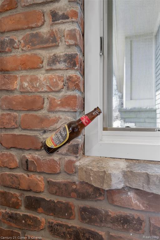Original Stroh's bottle found on the property, showcased on the brick wall.