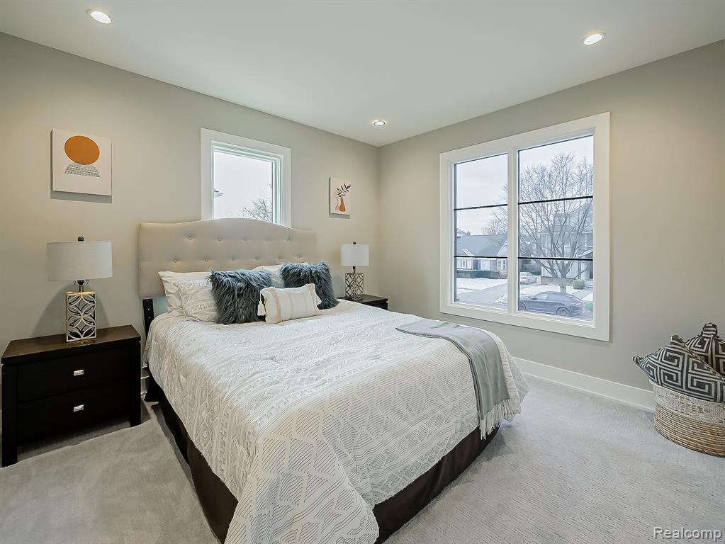 Carpeted bedroom with multiple windows and recessed lighting