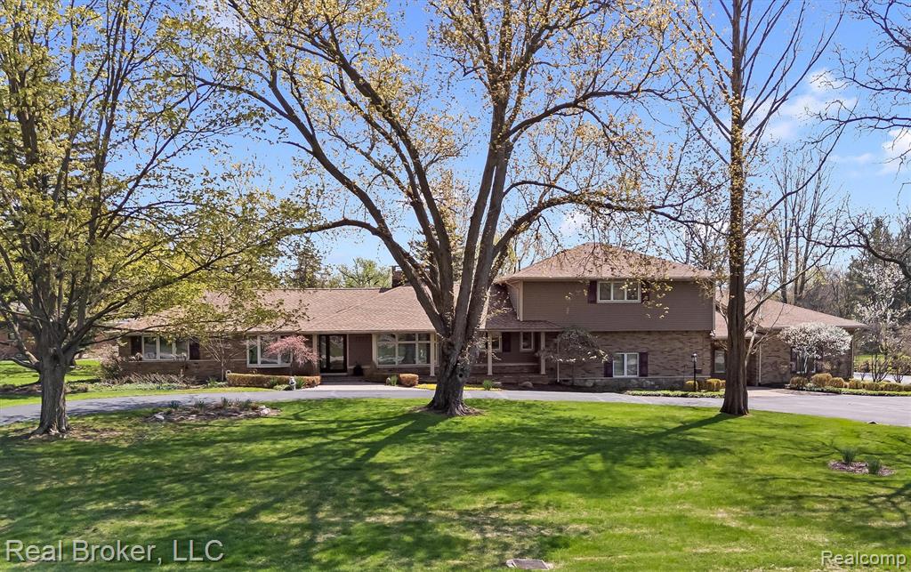 Traditional home featuring a front lawn and brick siding