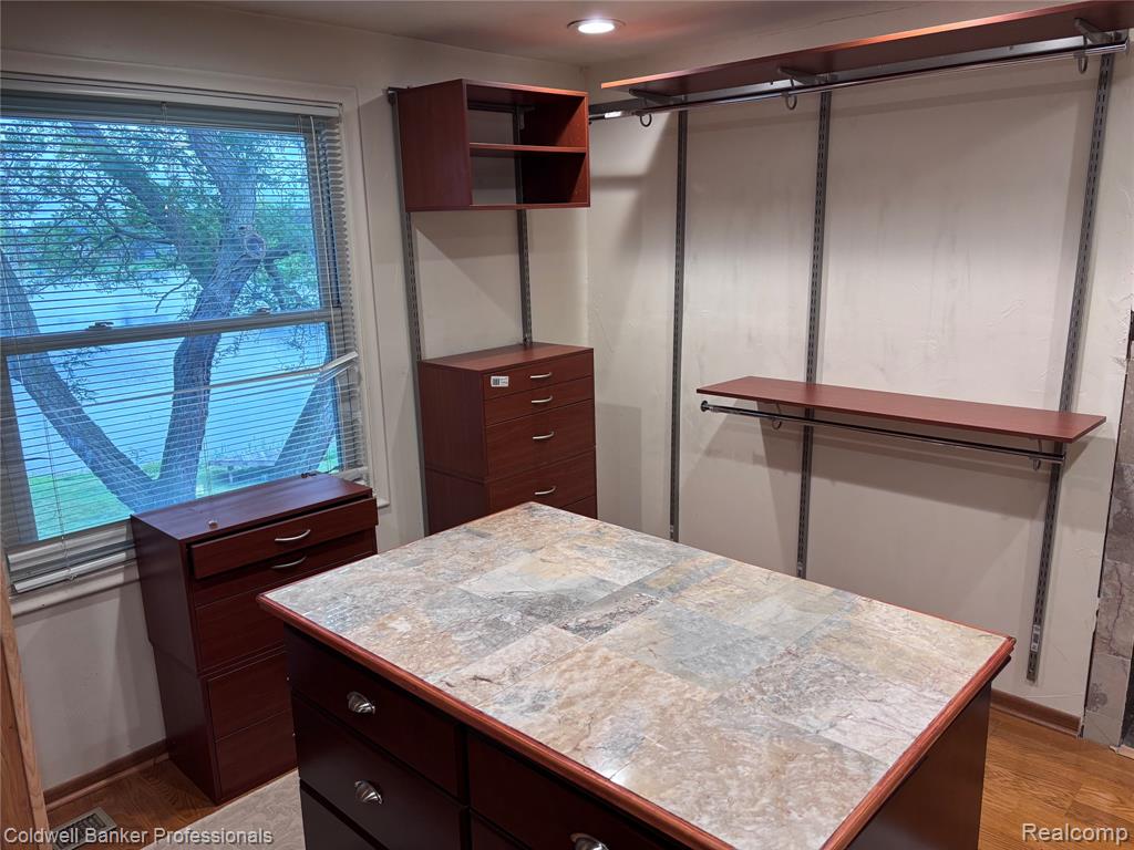 4th BR or Walk in closet featuring wood finished floors