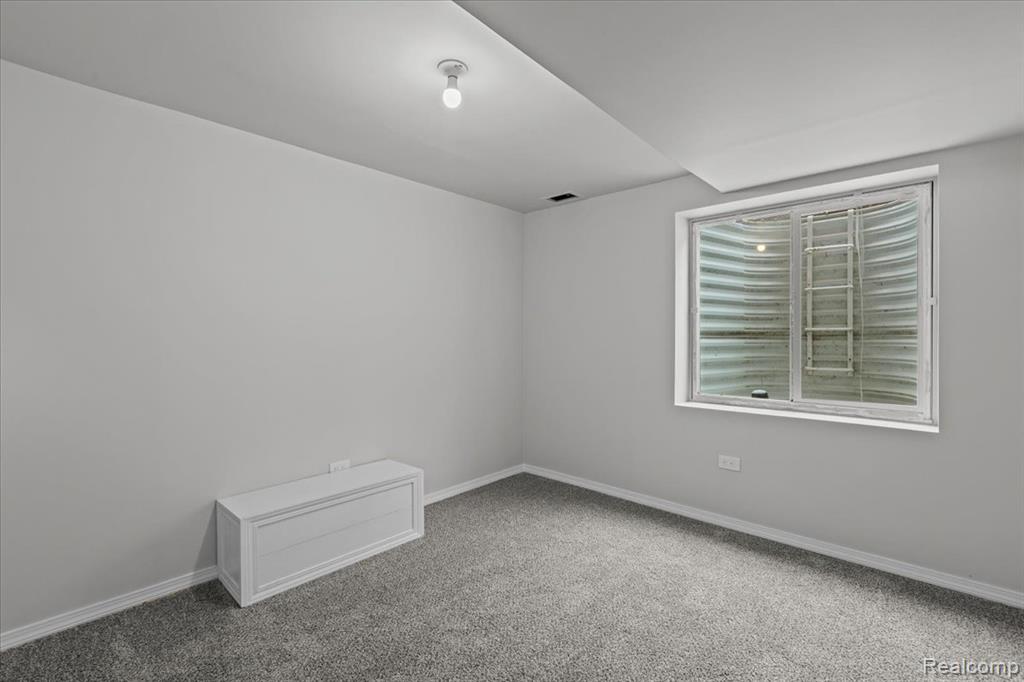 Snow covered property with brick siding