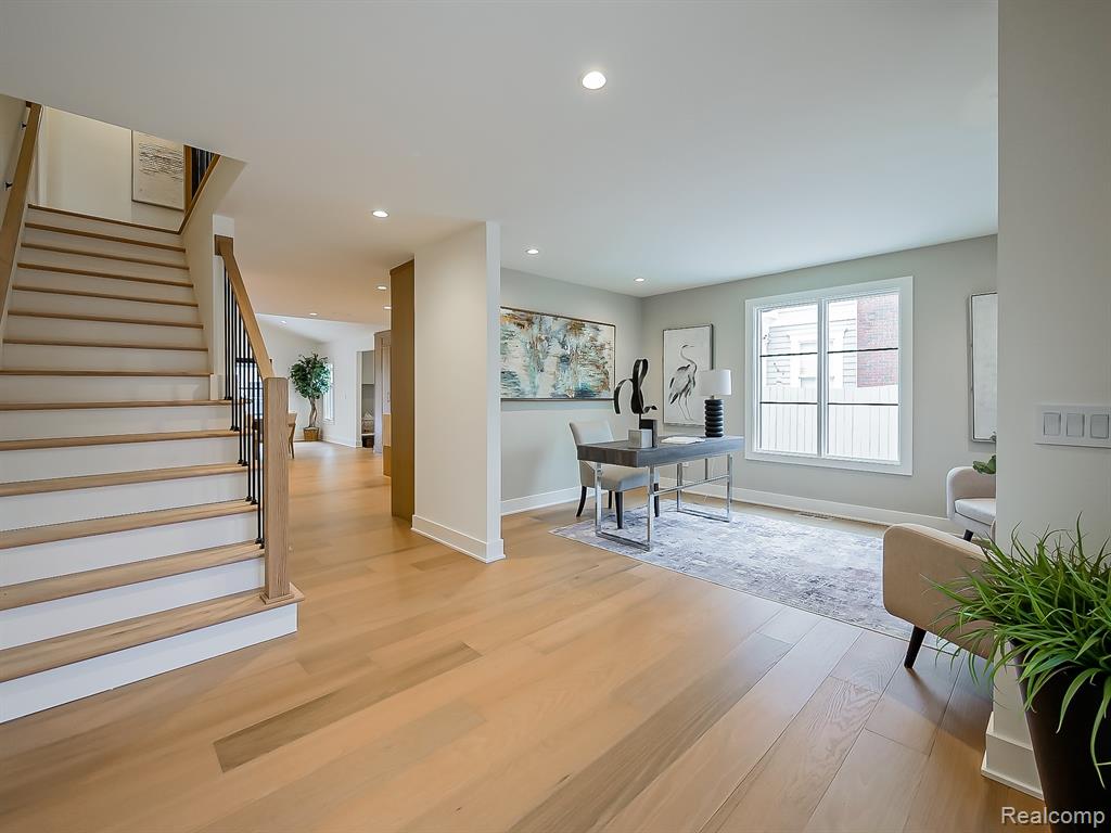 Office space featuring light wood-type flooring and recessed lighting