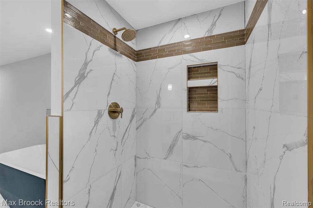 Bathroom featuring a marble finish shower