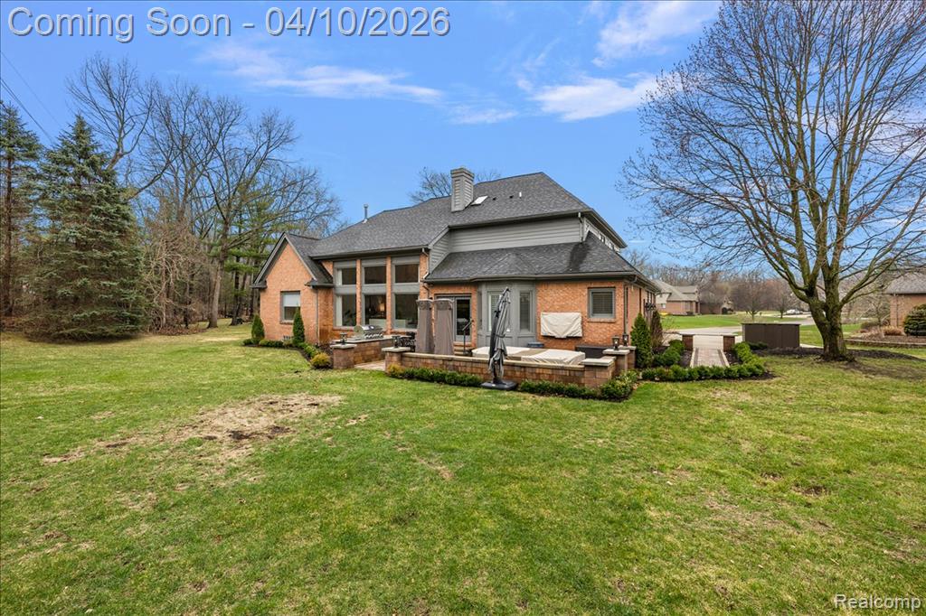 Rear Facade w/Beautiful Landscape, Paver Patio & Outdoor Kitchen