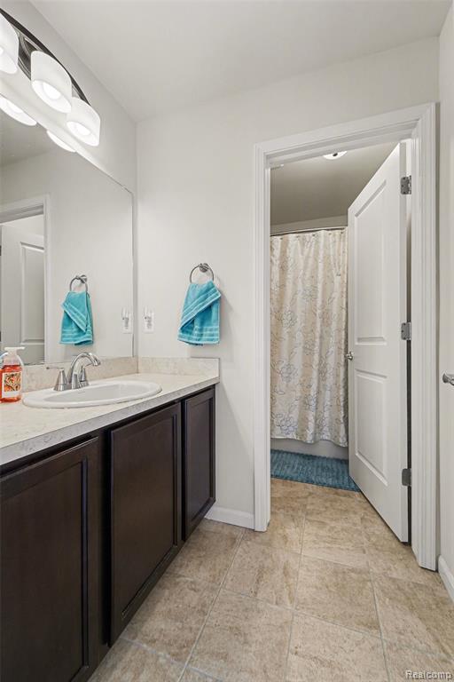 Bathroom with vanity and curtained shower