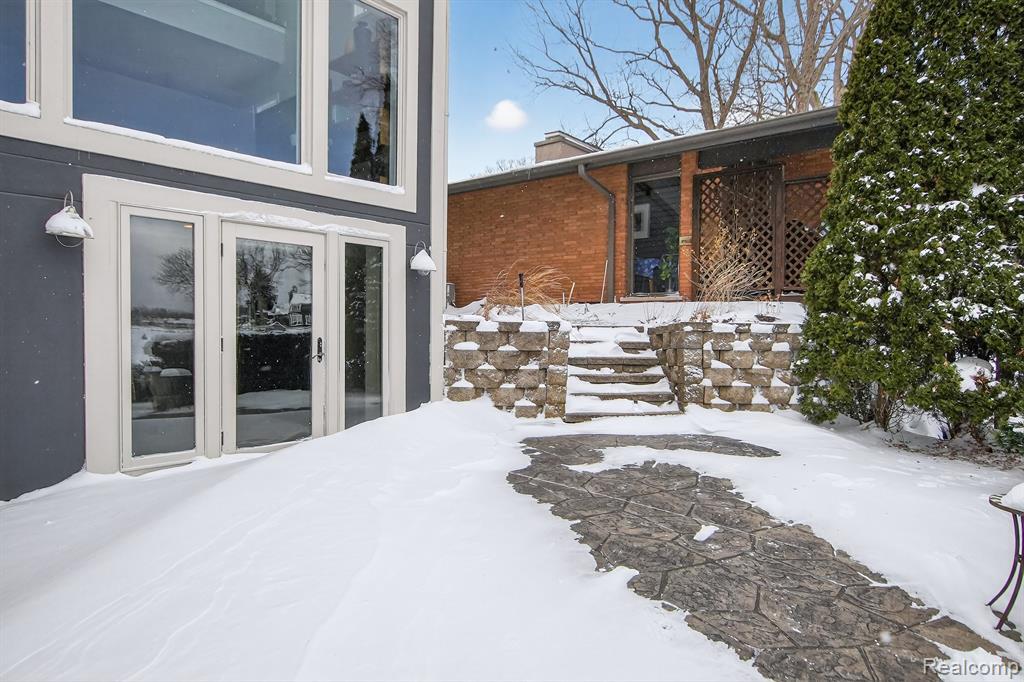 Rear view of property with stucco siding, a deck, and a patio area